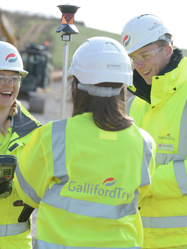 Image of three people on a building site